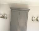 Grey painted medicine/linen bath cabinet with appliance pull.