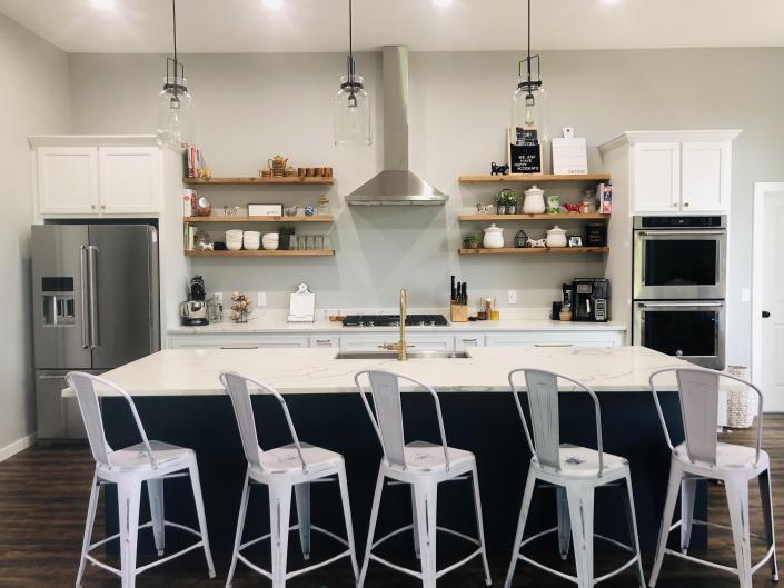 Custom Maple Kitchen cabinets. Shaker style doors and drawers. White Lacquer and Anchors away paint. Accented with solid cedar floating shelves.